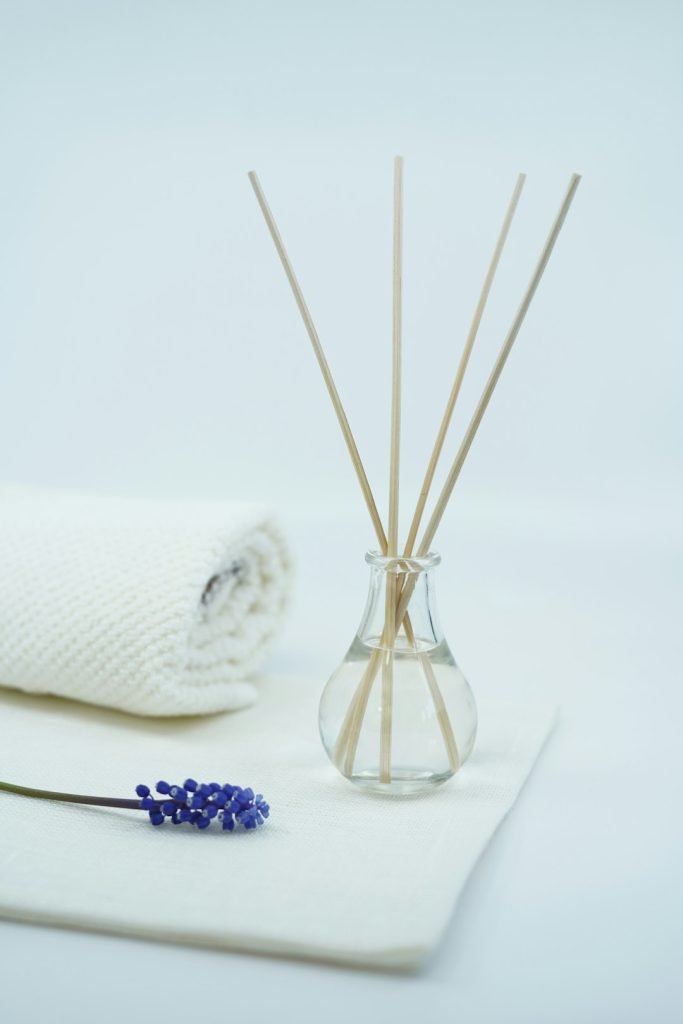 Beautiful image with spa and relaxing concept with scented oil fragrance diffuser and candles and flower